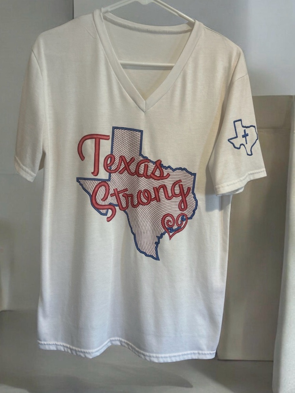 Texas Strong Graphic V-Neck Short Sleeve Tee - White with Red & Blue Print.